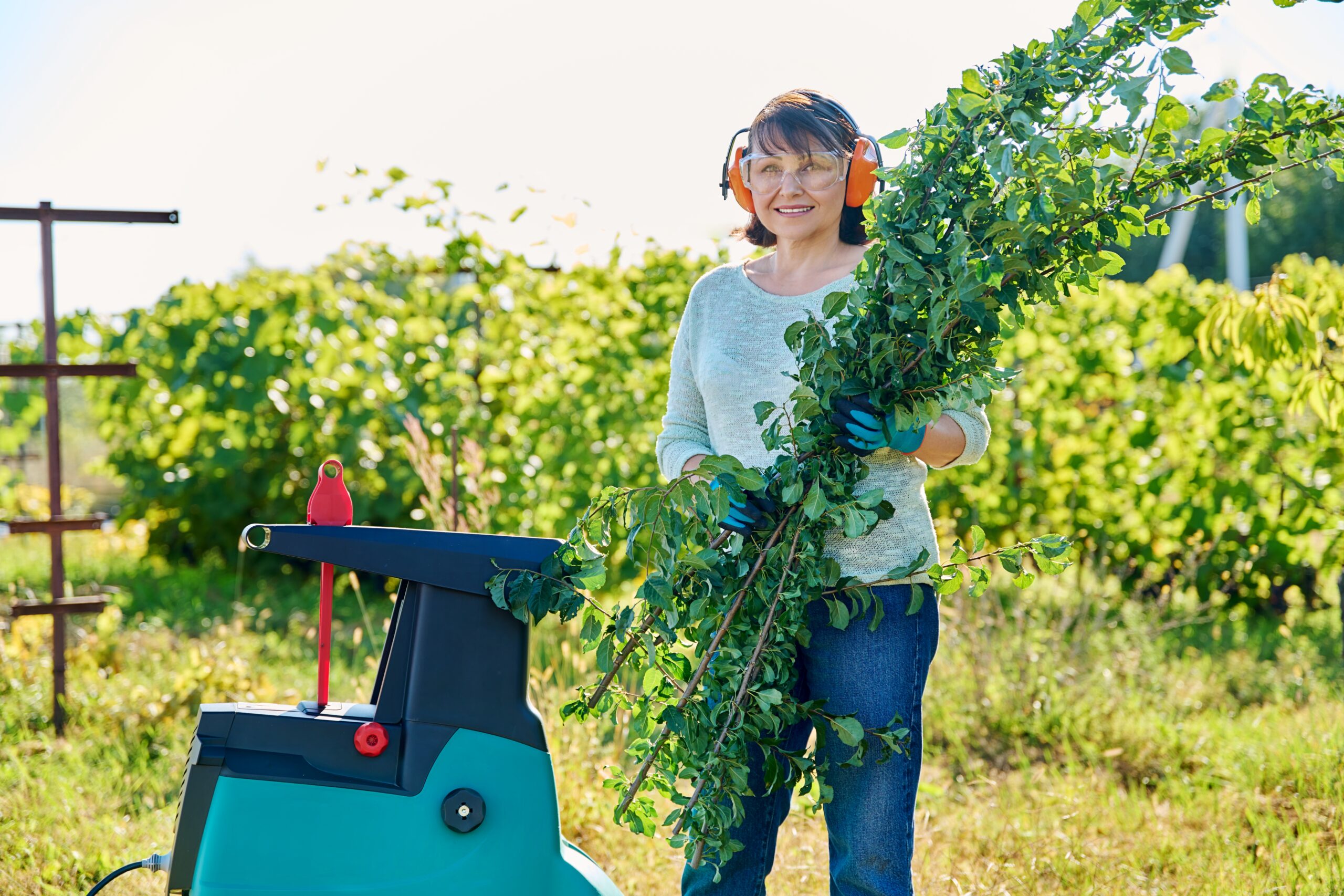woman-using-electric-garden-shredder-for-branches-2024-12-08-03-55-01-utc-scaled.jpg