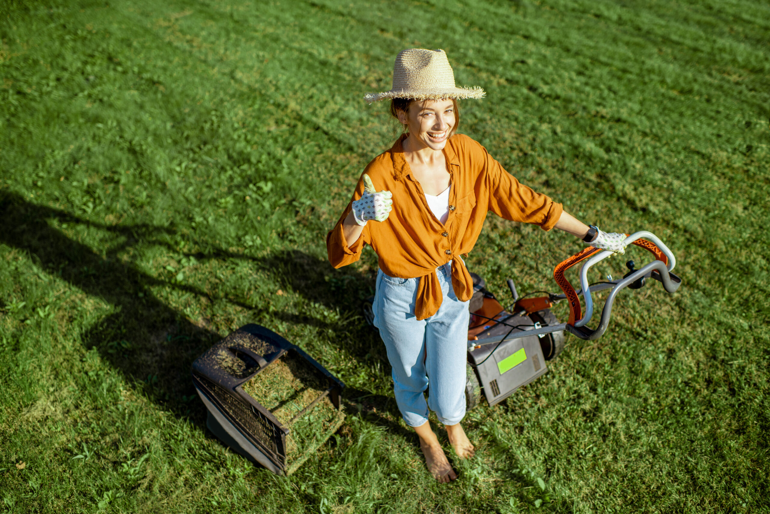 woman-with-lawn-mower-on-the-backyard-2023-11-27-05-25-02-utc-scaled.jpg